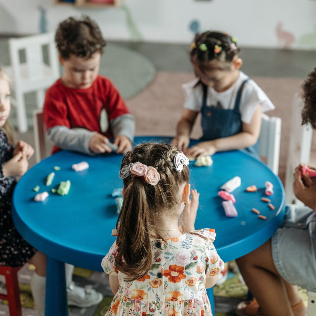 children sitting around the table playing all together